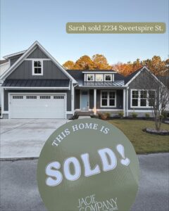 Should I sell my house? “Sold” sign displayed in front of a gray house, indicating a completed real estate sale